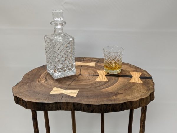 B Art - Walnut Whisky Stand - Close-up of a walnut whiskey stand featuring three live-edge walnut slabs with organic contours and durable wood posts