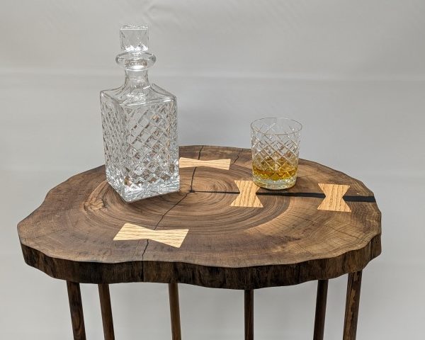 B Art - Walnut Whisky Stand - Close-up of a walnut whiskey stand featuring three live-edge walnut slabs with organic contours and durable wood posts